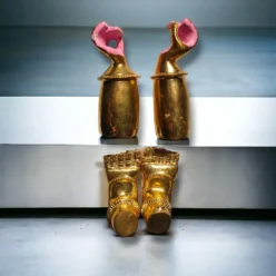 Brass hands and feet placed on Jagannath deities, enhancing a home puja space with traditional elements.