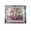 Silver Jagannath Murti displayed with Nirmalya Mahaprasadam, Sanjua, and a puja guide.
