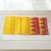 A Beautiful Yellow Silk Pata for Shri Jagannath Mahaprabhu draped over a statue of the deity.