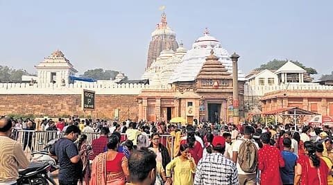 Crowd in traditional clothing before a temple complex, featured in the Divine Rajendrabhishek article