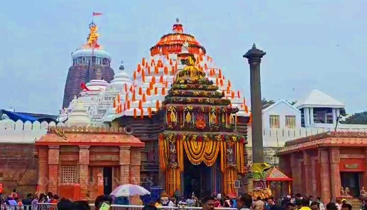 Temple building with a tall spire and crowd