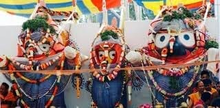 Group of people in costumes before a vibrant mural, featured in the Snan Purnima article