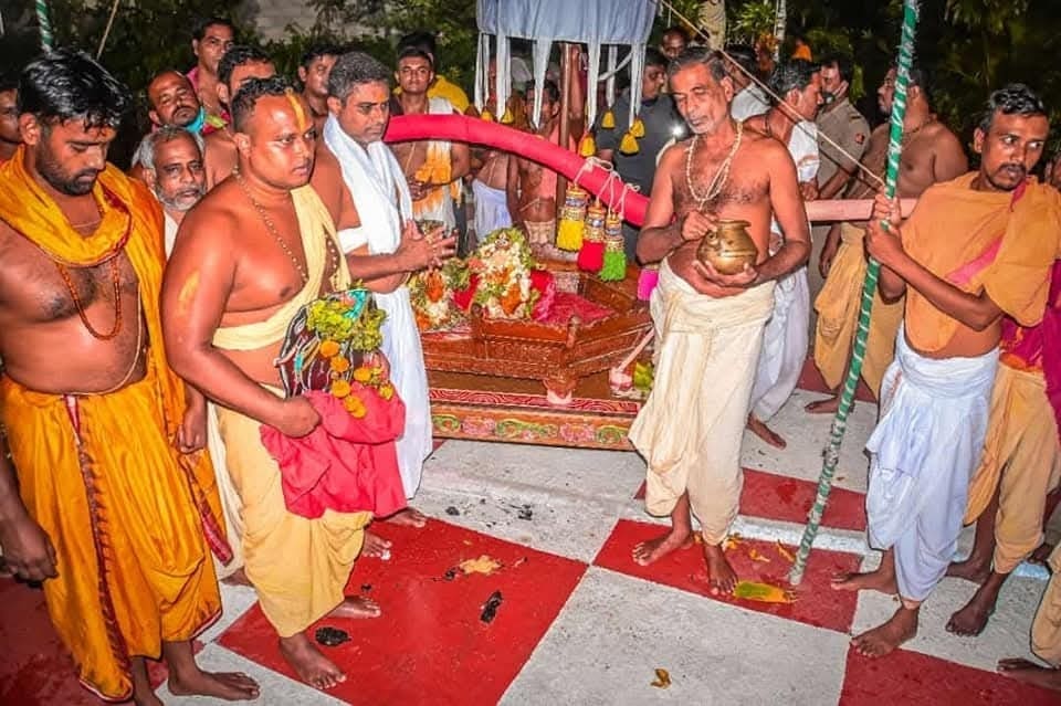 Group of men gathered around a table, featured in the Andha Mandira Hati Prastaba article